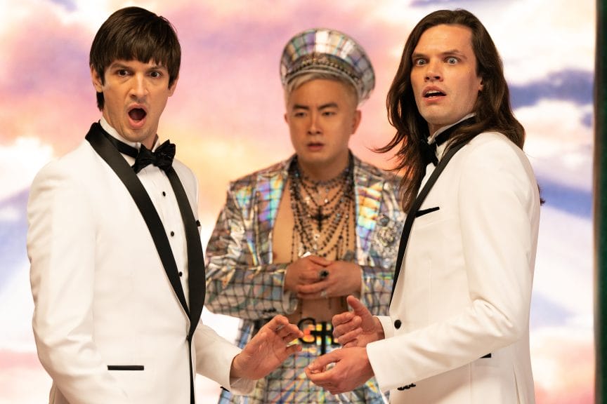 Still from 'Dicks: The Musical' in which the two lead actors meet God, played by Bowen Yang.