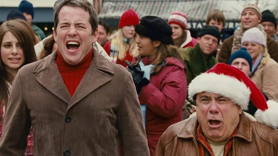 Two men featured prominently in the frame of the photo screaming amongst a crowd of people in the background.
