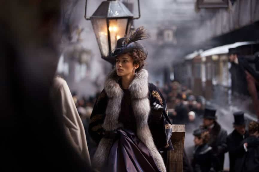 Kiera Knightley as Anna Karenina in 19th century attire, in a dress and fur scarf. 