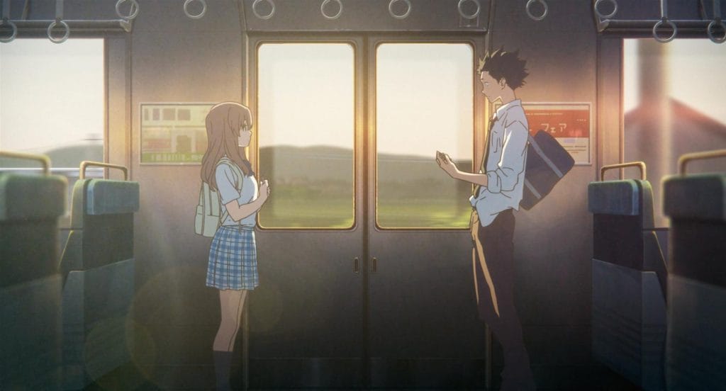 Main characters Shouko and Shoya stand together in a train, the sunlight setting a warm aura to both. 