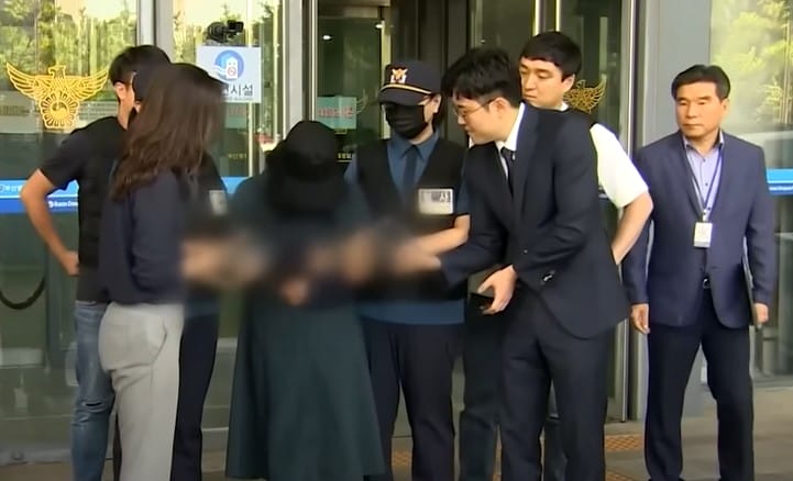 Image shows Jung Yoo-jung under police arrest.