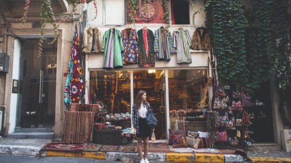 Woman standing outside of vintage store in Turkey.
