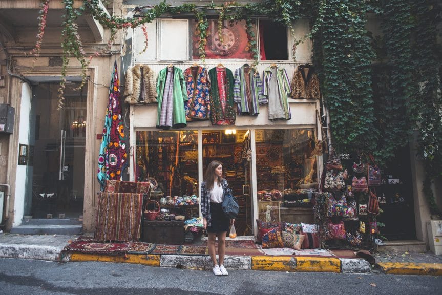 Woman standing outside of vintage store in Turkey.