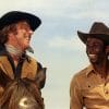 Cleavon Little and Gene Wilder laugh together in a scene from 'Blazing Saddles"