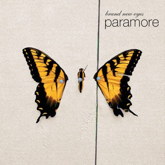 Album cover for Paramore's album 'Brand New Eyes.' A butterfly is on a cream background with the band name and album title in the top right hand corner.