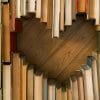 Spine down books creating a heart.