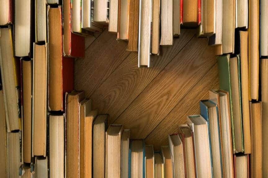 Spine down books creating a heart.