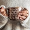 Sweater girl holding a mug.