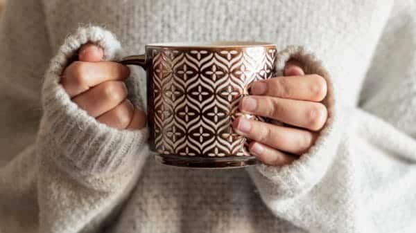 Sweater girl holding a mug.