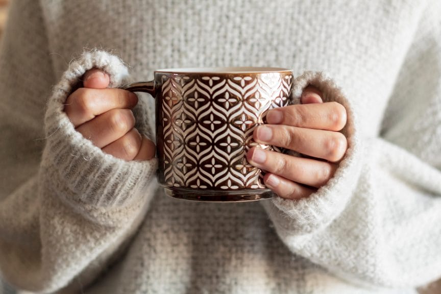 Sweater girl holding a mug.