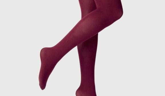 A person wearing burgundy colored tights.
