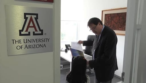 Still of the President of University of Arizona and Adhara in an office