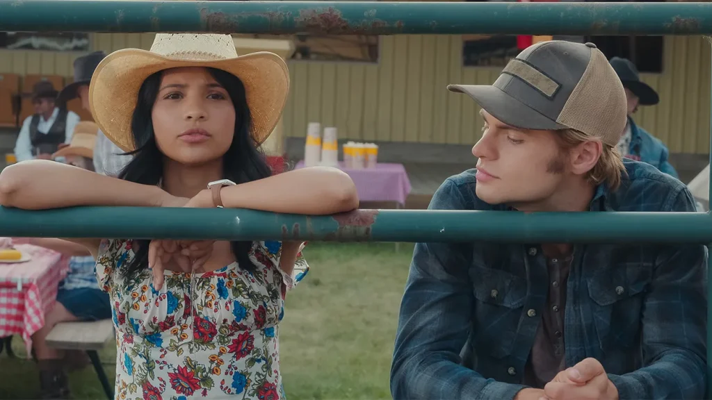 Jackie and Cole lean side by side on a fence - Netflix original series