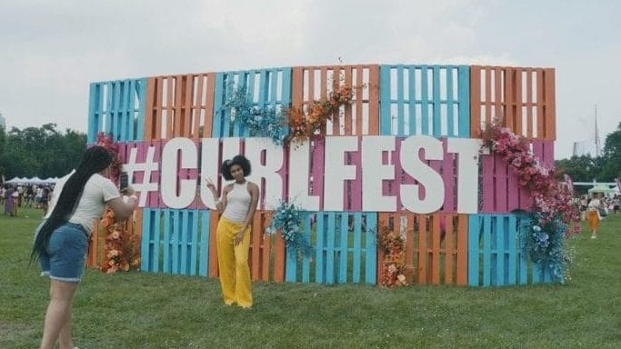 Attendee poses for a photo at the 2023 Curlfest on Randall's Island