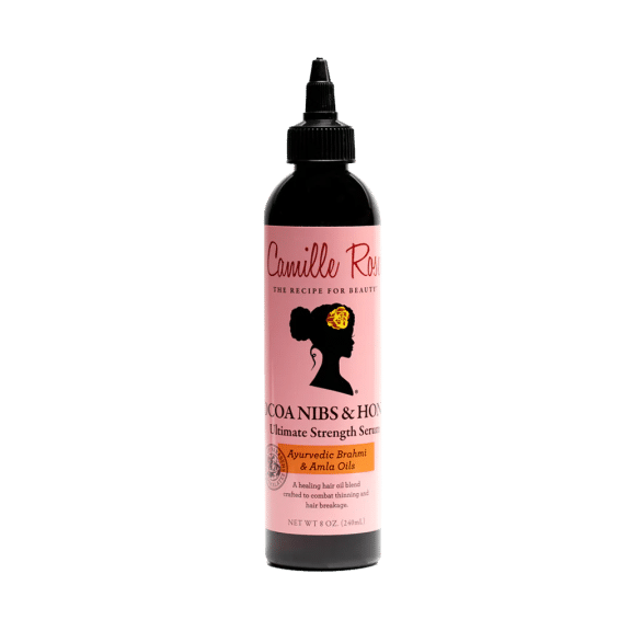 a brown and pink bottle of Camille Rose hair serum.