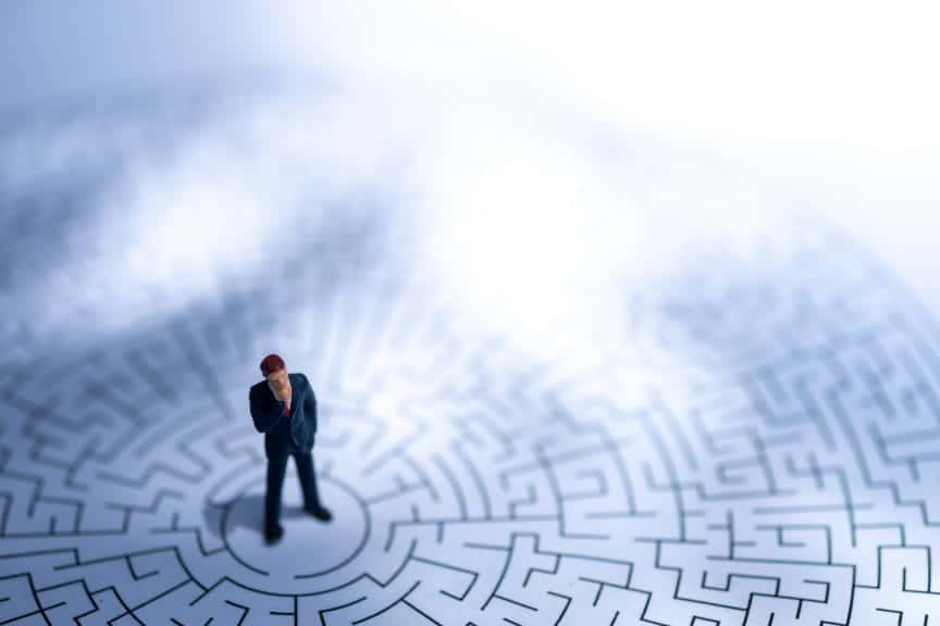 Man standing in a maze, exposed to endless options