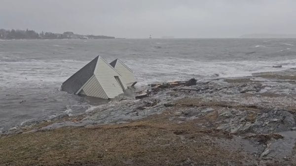 Image showing Maine fishing shacks being swept out to sea