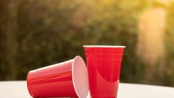Picture of two plastic red solo Cups; one in a laying down postion and one in a straight-up postion.