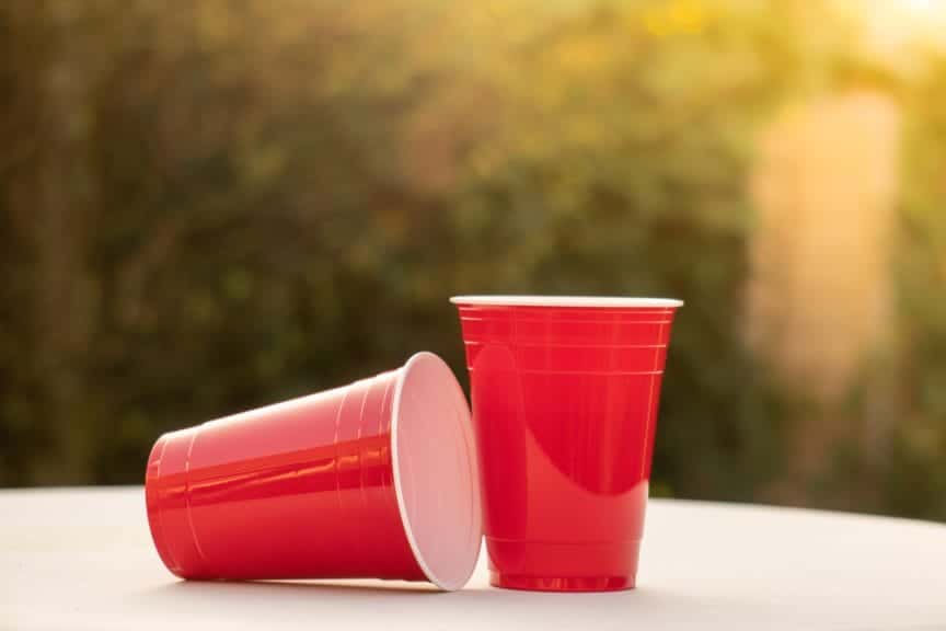 Picture of two plastic red solo Cups; one in a laying down postion and one in a straight-up postion.