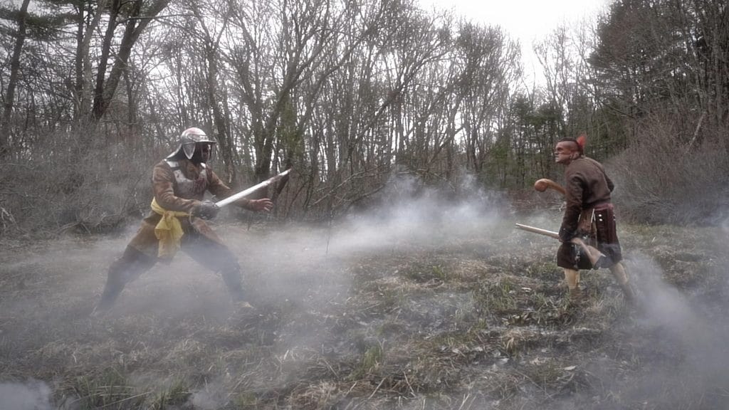 A standstill between Jonatan Fletcher (Benton Guinness) and a Wampanoag warrior (Drew Shupter-Rayvis) during the King Philips War. Credit: Atun-Shei Films