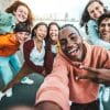 multicultural group of friends taking a selfie.