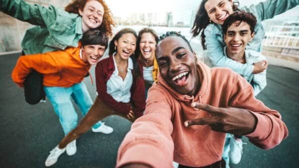 multicultural group of friends taking a selfie.