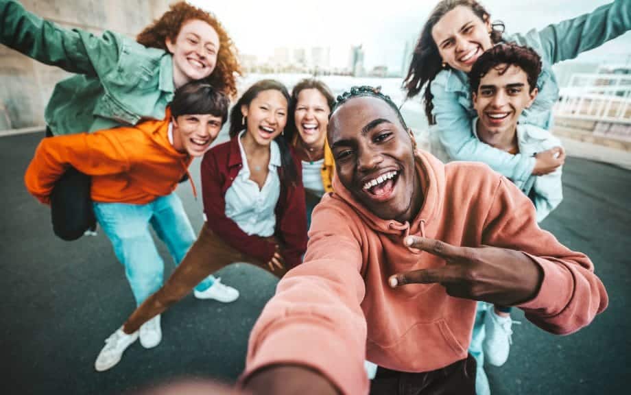 multicultural group of friends taking a selfie.