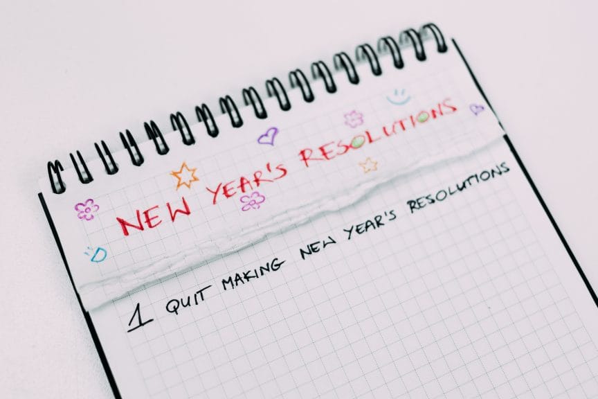 Notebook message that reads "New Year's Resolutions: 1. Quit making New Year's resolutions."
