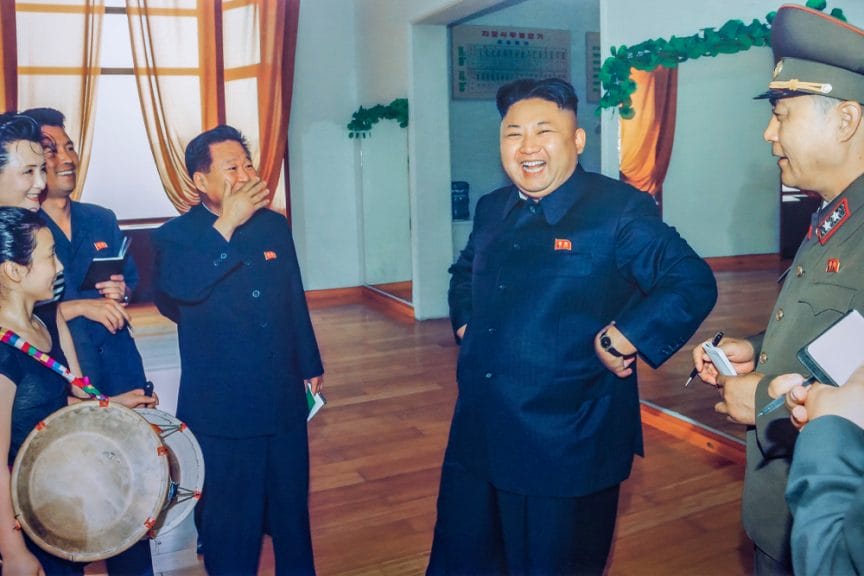 Kim Jong-un laughing/smiling with a group of people
