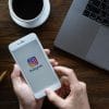 A woman hand holding iphone 6 with login screen of instagram application.
