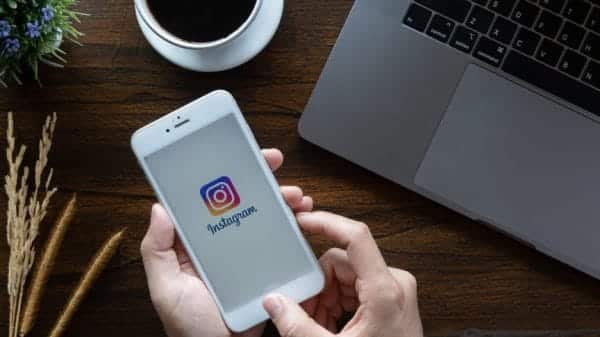 A woman hand holding iphone 6 with login screen of instagram application.