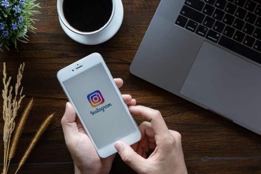 A woman hand holding iphone 6 with login screen of instagram application.
