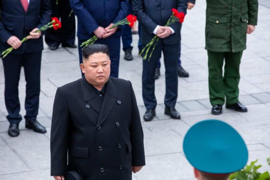 Kim Jong un standing at a memorial