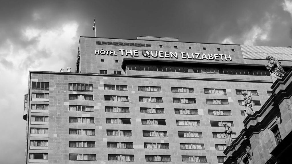 Black and white photography of the Fairmount Queen Elizabeth Hotel, with a very moody sky.