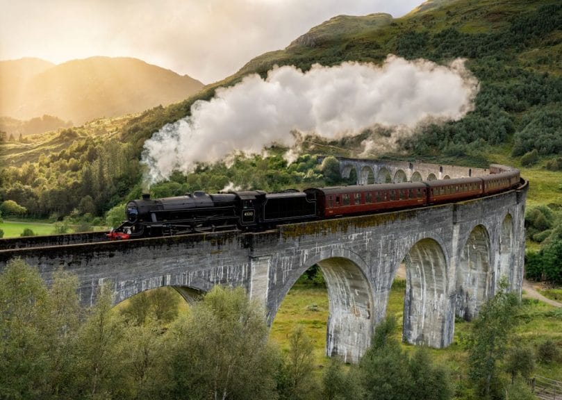 Steam train crossing a viaduct in the Highlands of Scotland, Scotland UK