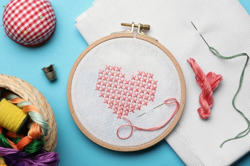 Cross stitch embroidered heart on hoop.