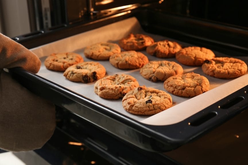 Image of cookies being put in the oven.