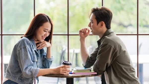 Two couples sitting by a window in a restaurant