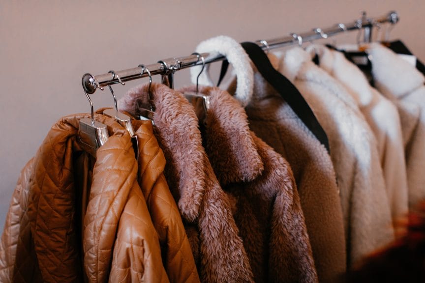 A rack of coats in different styles