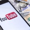 YouTube logo surrounded by dollar bills