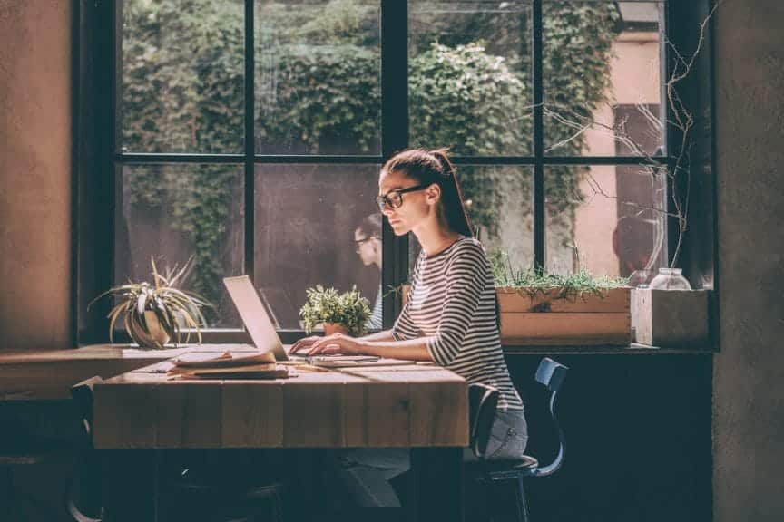 Girl working on her computer at a coffee shop.