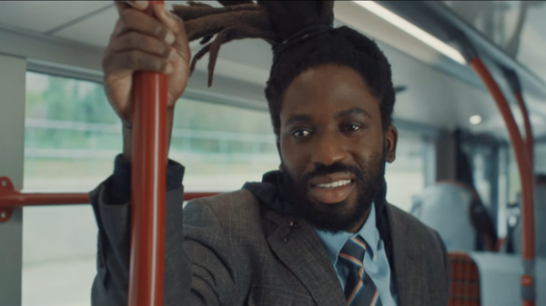 Image shows main character in Dreaming Whilst Black on a bus