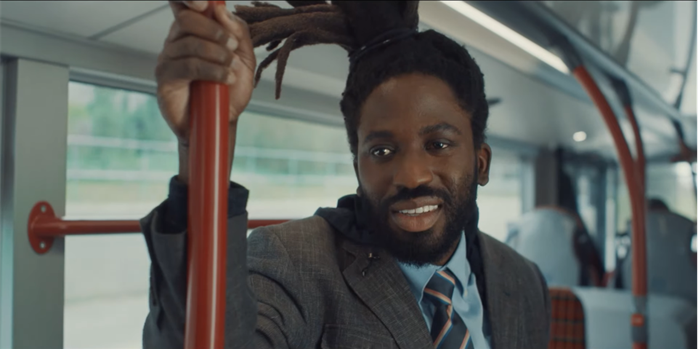 Image shows main character in Dreaming Whilst Black on a bus