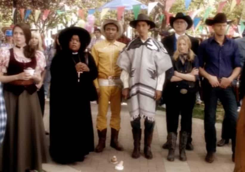 The cast of Community dressed in apparel similar to that of a Western movie before the start of a paintball war.