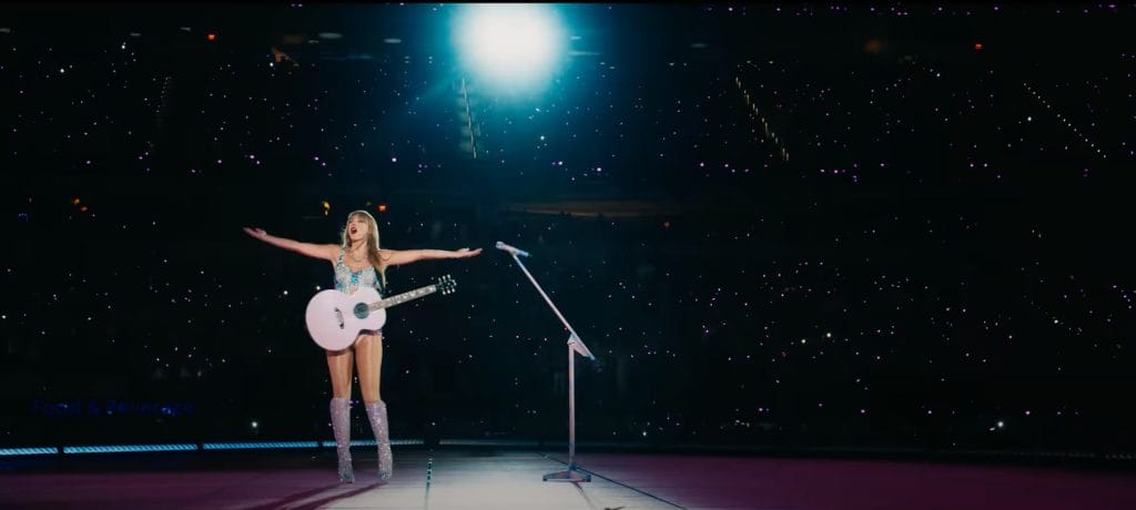 Taylor Swift performing to a crowd on tour