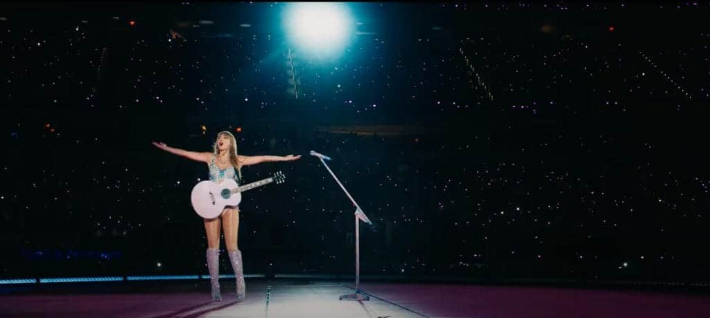 Taylor Swift performing to a crowd on tour