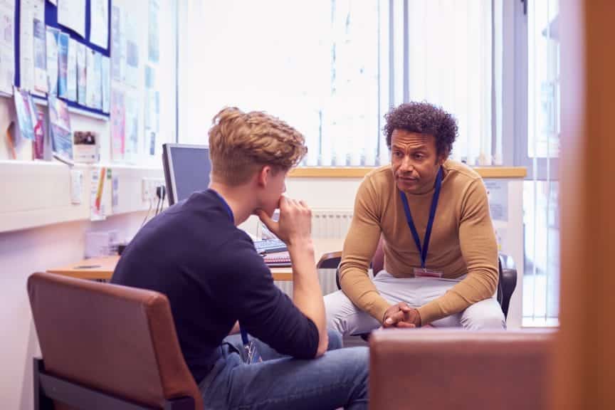 College Student Meeting With Campus Counselor Discussing Mental Health Issues