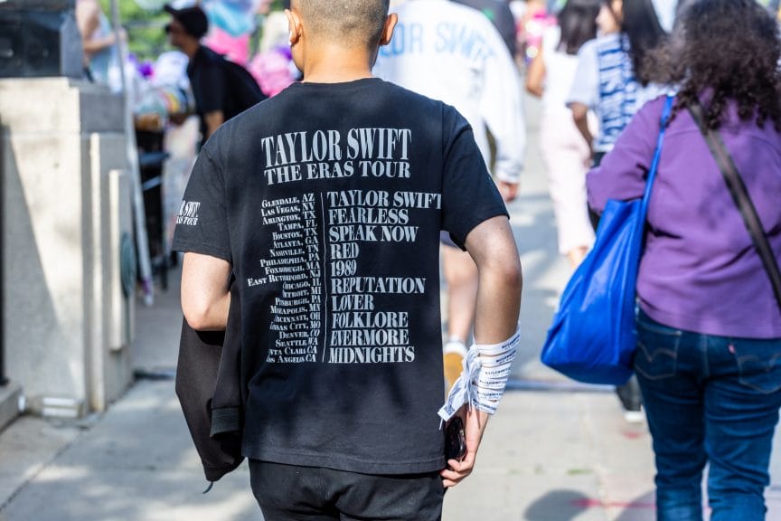 A fan attending a Taylor Swift concert wearing Taylor Swift merchandise. 