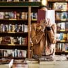 woman reading a book in a library or book shop