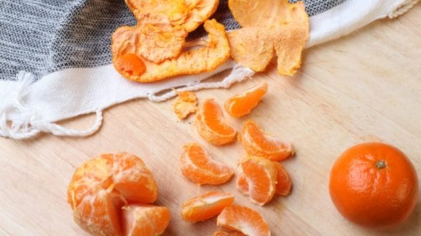 Oranges and peel on table